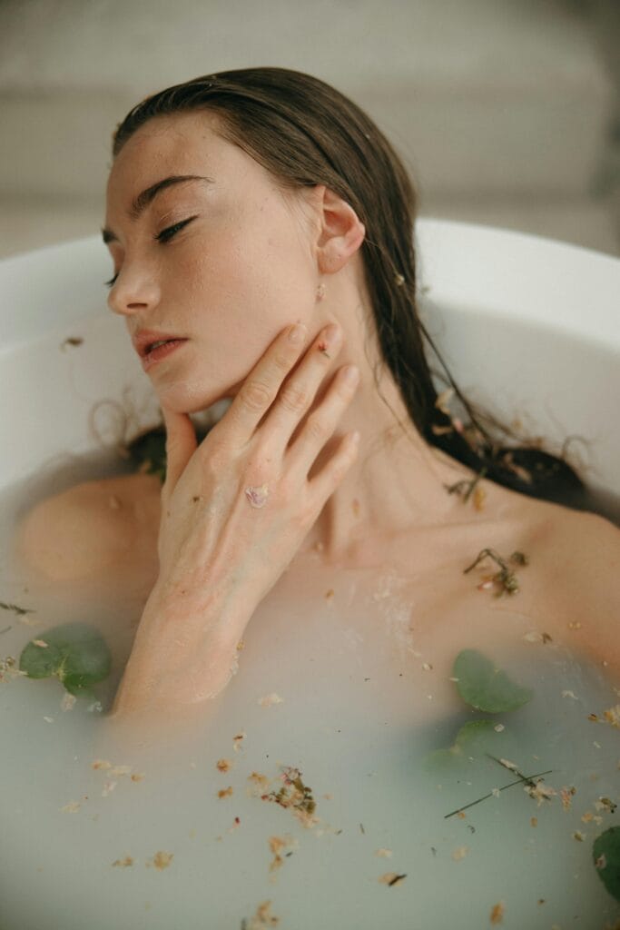 The Wonders of Bath Salts Serene woman enjoying a calming bath with botanical elements for relaxation.