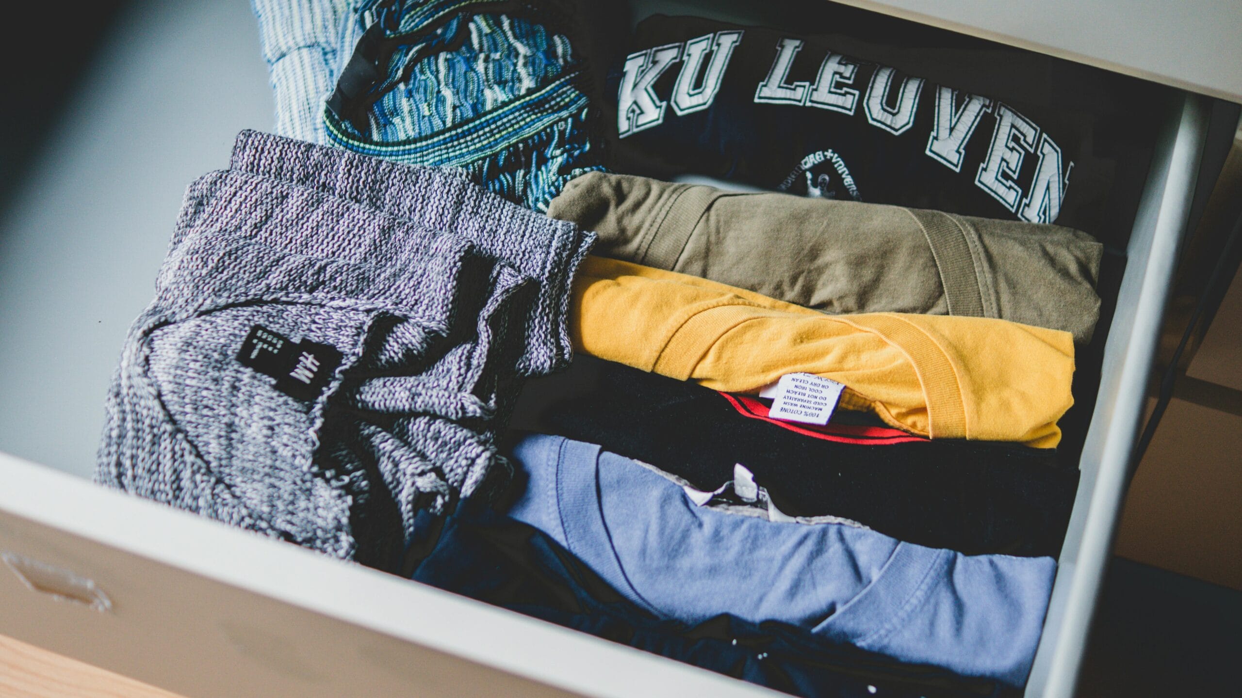 pexels photo 581087 581087 A neat arrangement of clothes and T-shirts in a drawer, showcasing casual wear.